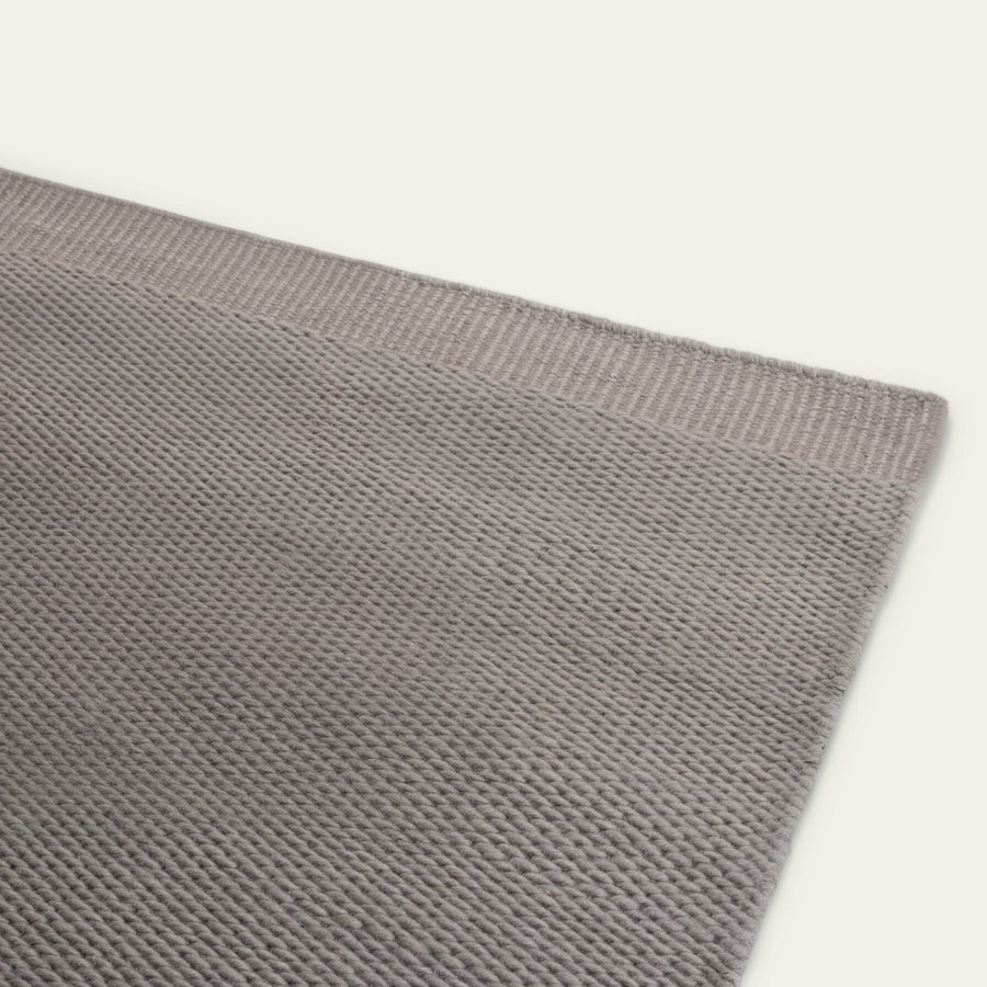 Close-up of a Fable Slate gray wool rug with a textured weave. #slategray