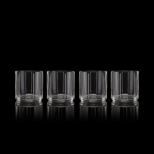 Set of four Fable ribbed rocks glasses on a black background