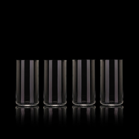 Set of four smoke gray tall drinking glasses on a black reflective surface