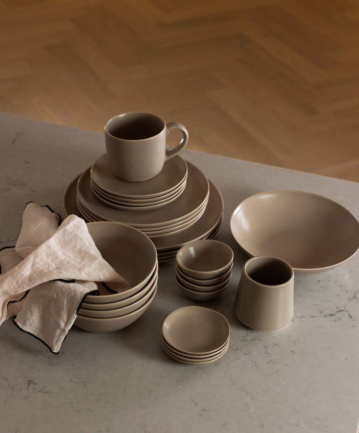 Complete Dinnerware Set by Fable Home, shown in Desert Taupe.