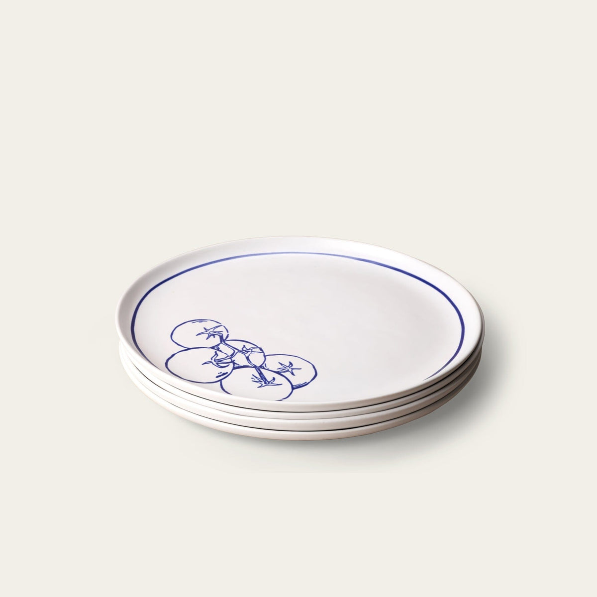 Stack of white plates with blue floral design on a light gray background