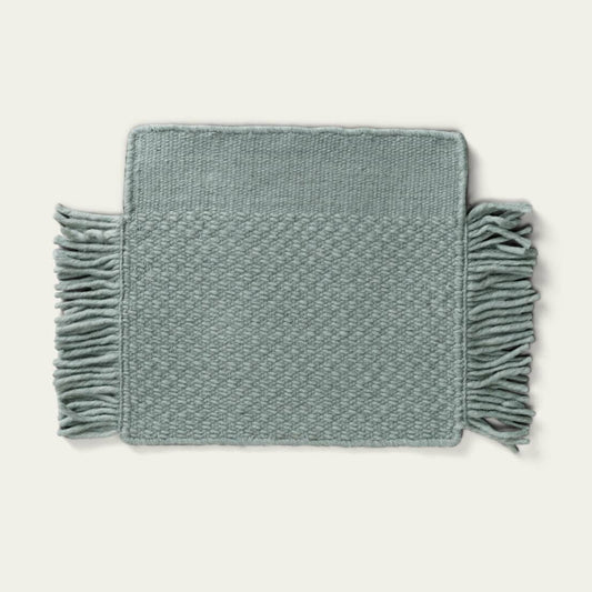 Fringe Wool Rug on a light beige background. #sagegreen