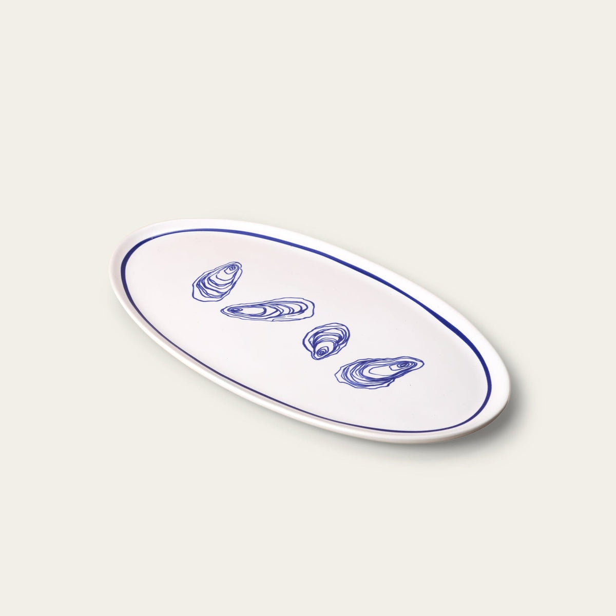 Oval ceramic plate with blue oyster illustrations on a light gray background