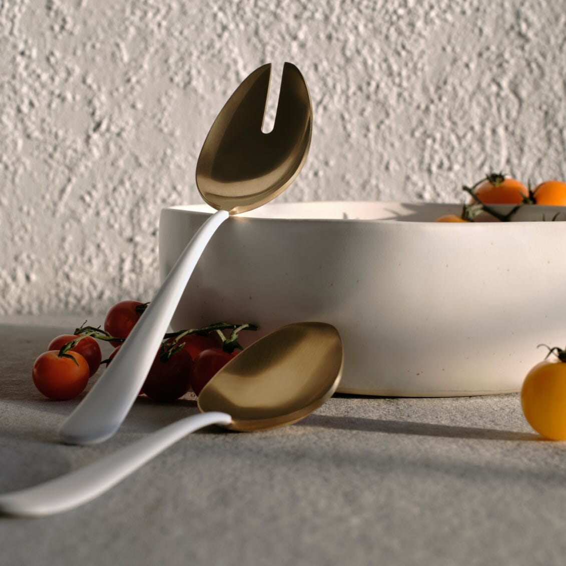 Serving spoons flatware by Fable Home, shown in a goldandwhite finish.