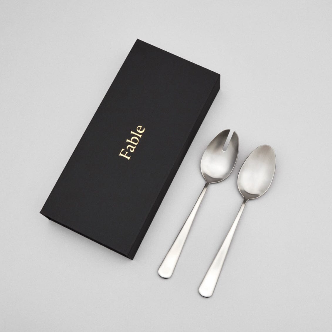 Serving spoons flatware by Fable Home, shown in a goldandwhite finish.