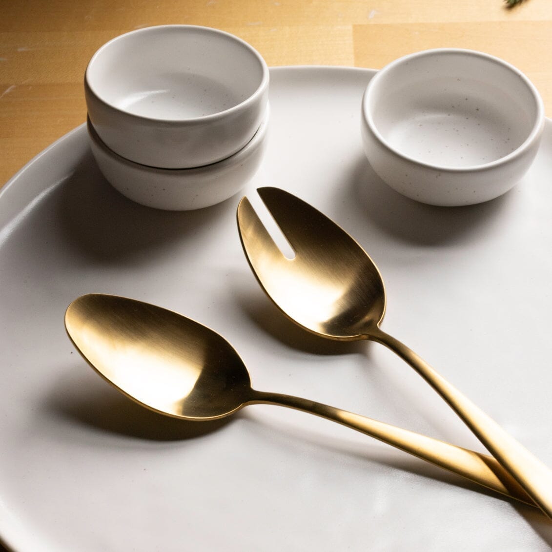 Serving spoons flatware by Fable Home, shown in a goldandwhite finish.