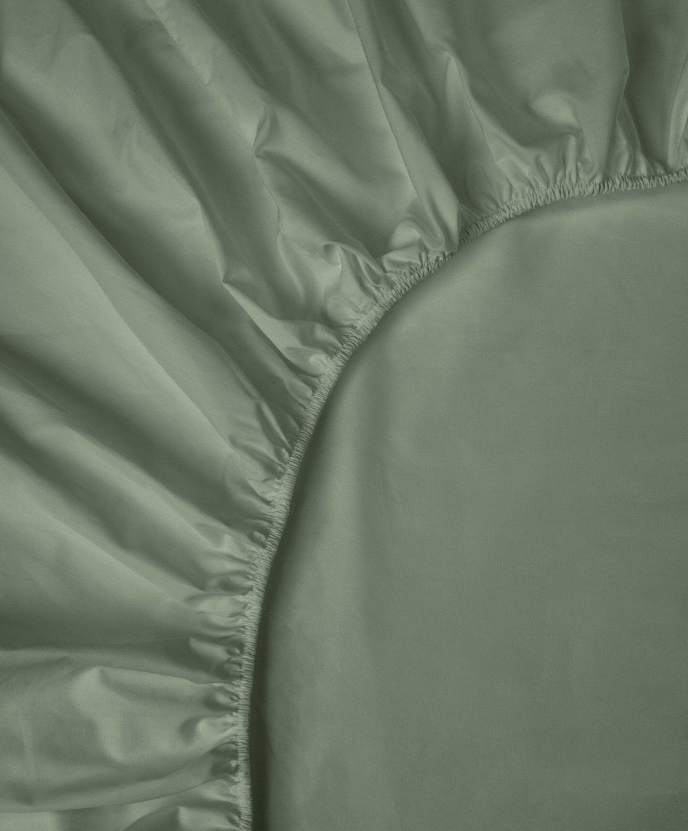 Percale Fitted Sheet by Fable Home, shown in Juniper Green.