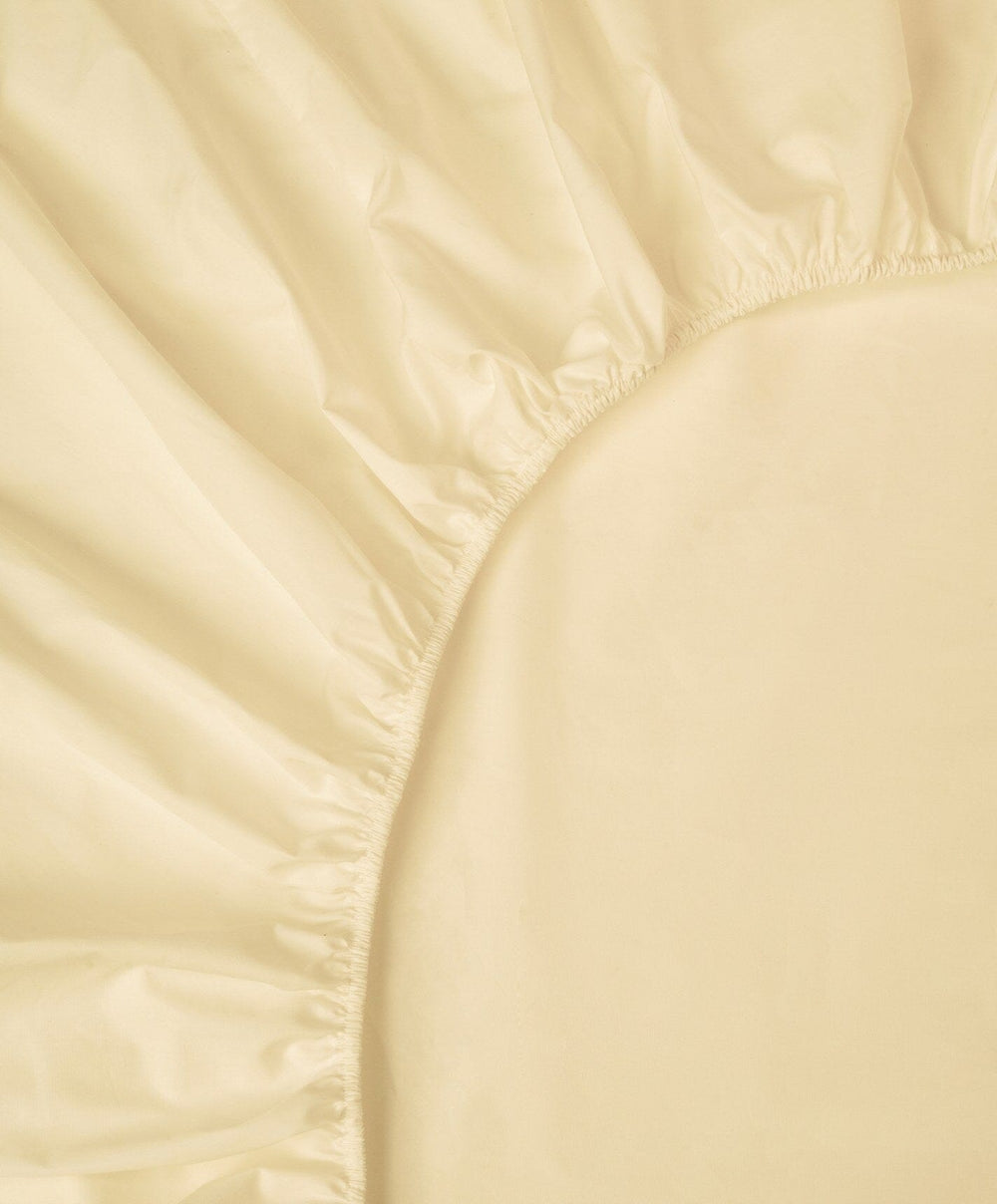 Percale Fitted Sheet by Fable Home, shown in Buttercup Yellow.