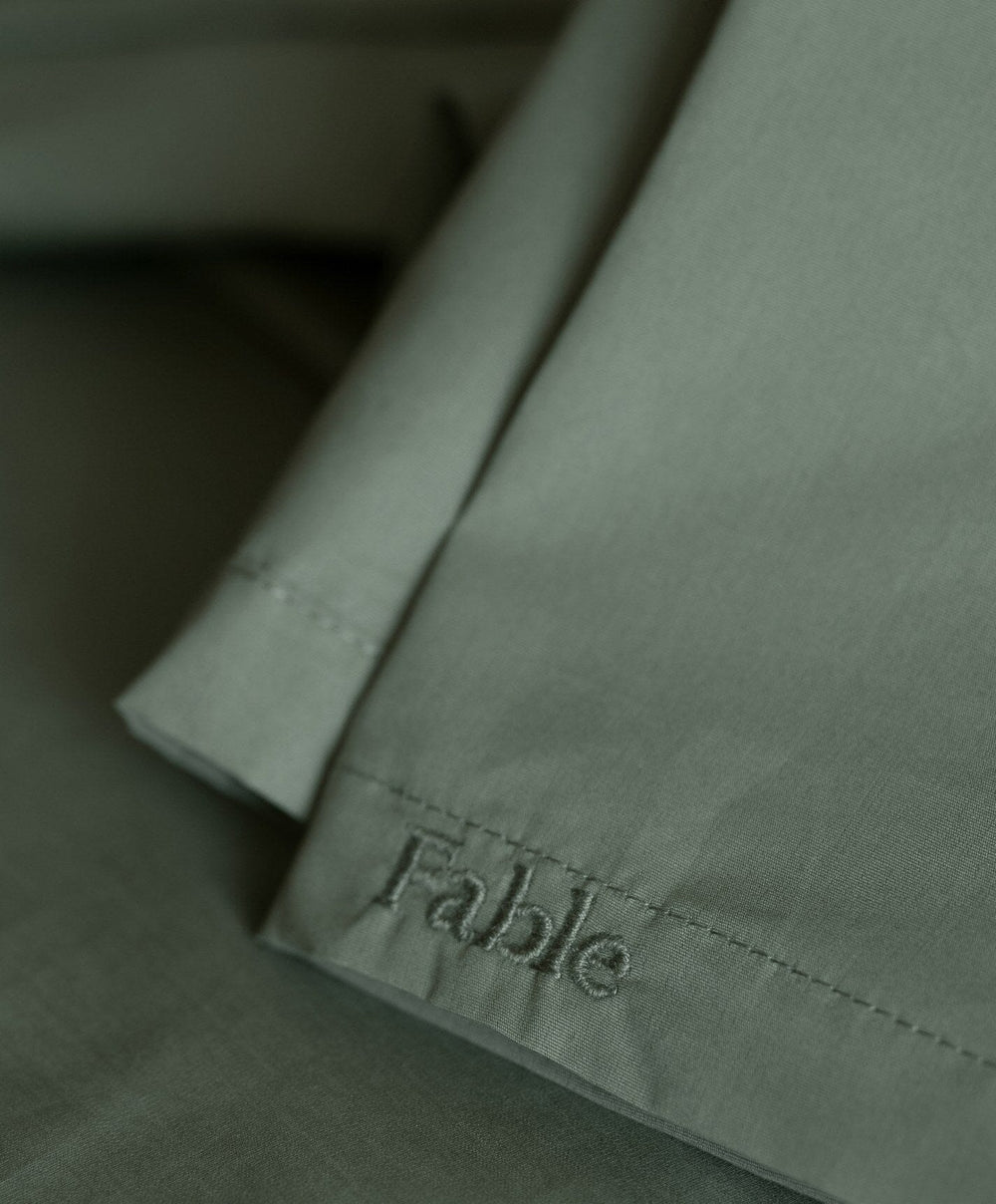 Percale Flat Sheet by Fable Home, shown in Juniper Green.