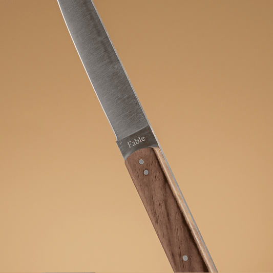 Knife with wooden handle and 'Fable' branding on a beige background #walnut